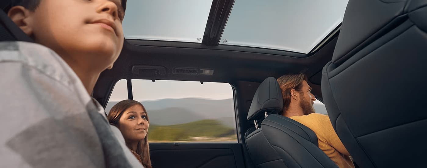 A group of kids are sitting in the back of a 2024 Lexus TX.