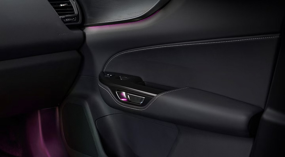 Purple ambient lighting in the cabin of a 2024 Lexus NX for sale near Flushing.