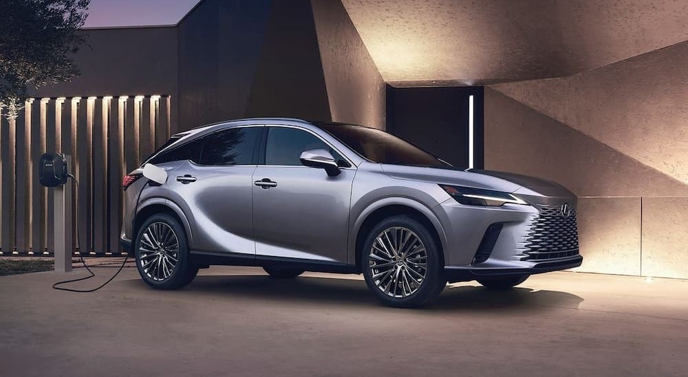 A silver 2024 Lexus RX is shown charging at a Lexus dealer near Freeport.