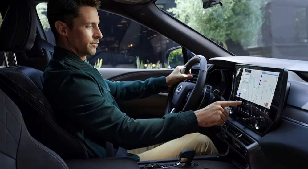 A person is shown touching the infotainment screen in a 2024 Lexus RX.