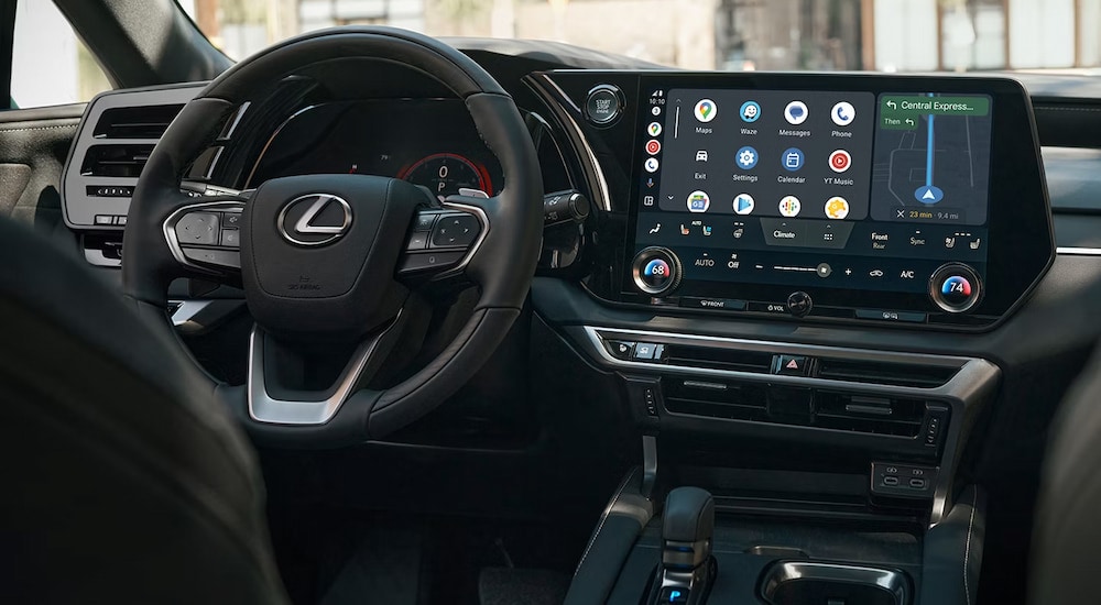 The steering wheel and infotainment screen in a 2024 Lexus RX for sale near Flushing.