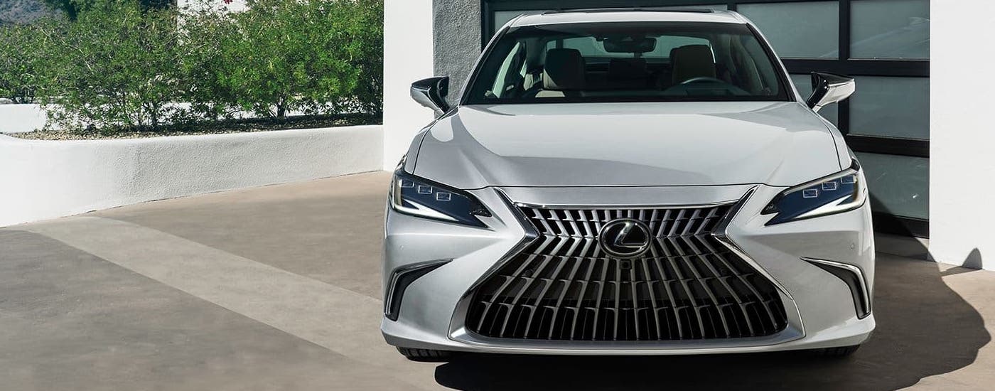 A silver 2024 Lexus ES for sale is shown from the front while parked.