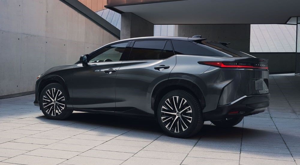 A dark grey 2023 Lexus RZ is shown parked on concrete.