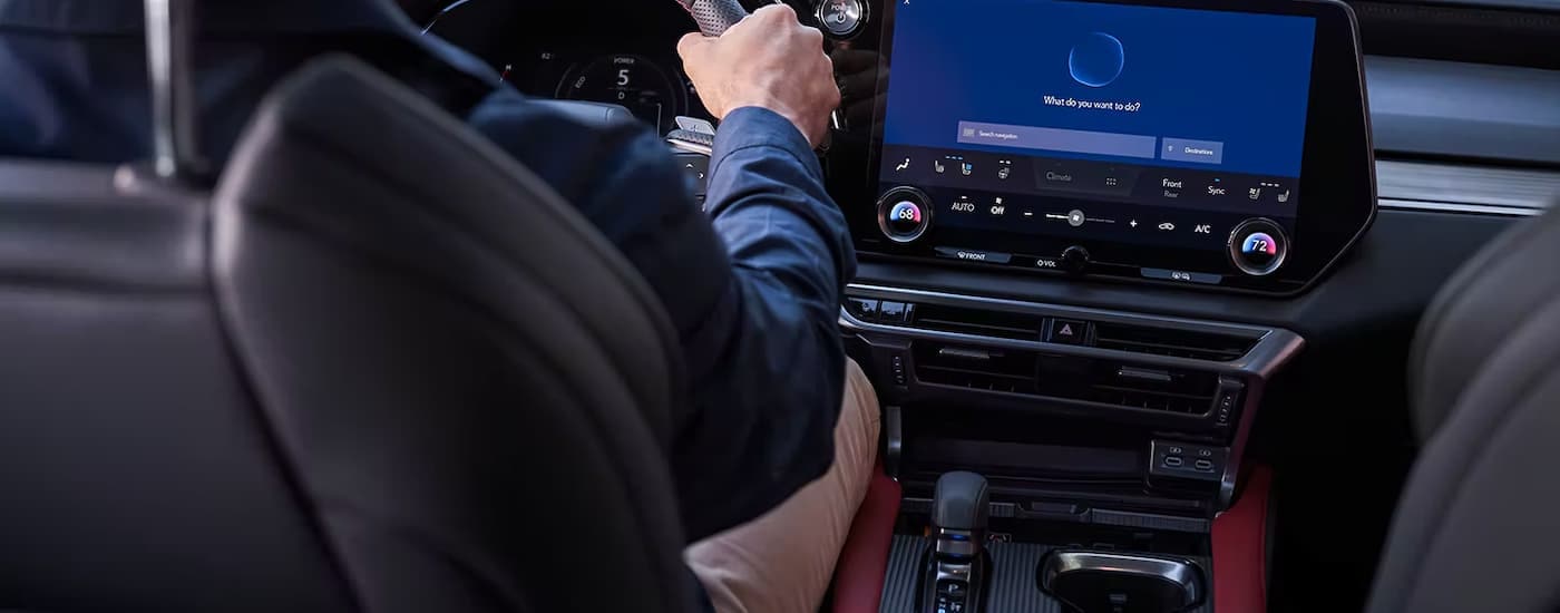 A man is shown driving in a leased 2023 Lexus RX 350.