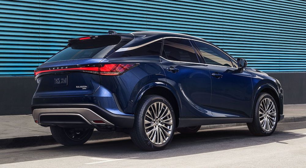 A blue 2024 Lexus NX is shown from the rear at an angle.