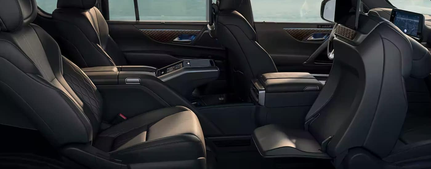 The black interior of a 2023 Lexus LX shows two rows of seating.