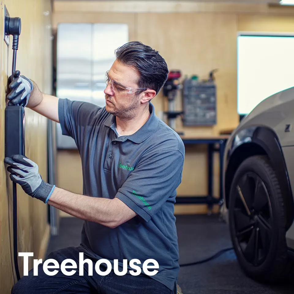  A person plugs a charger into their vehicle's charging port.