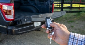 person using a key fob to operate the Ford F-150 power tailgate