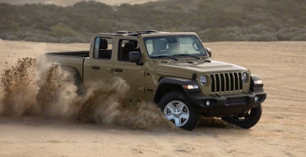 Jeep Gladiator driving in sand