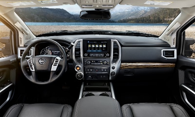 interior of the Nissan Titan showing front seats, steering wheel and dashboard