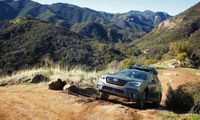 Subaru Outback driving up a hill off-road
