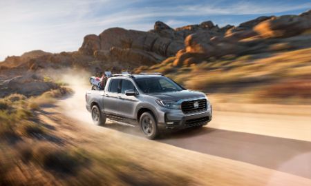 Honda Ridgeline driving on a dirt road