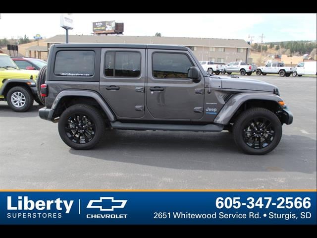 Used 2022 Jeep Wrangler Unlimited Sahara 4XE with VIN 1C4JJXP61NW229215 for sale in Sturgis, SD