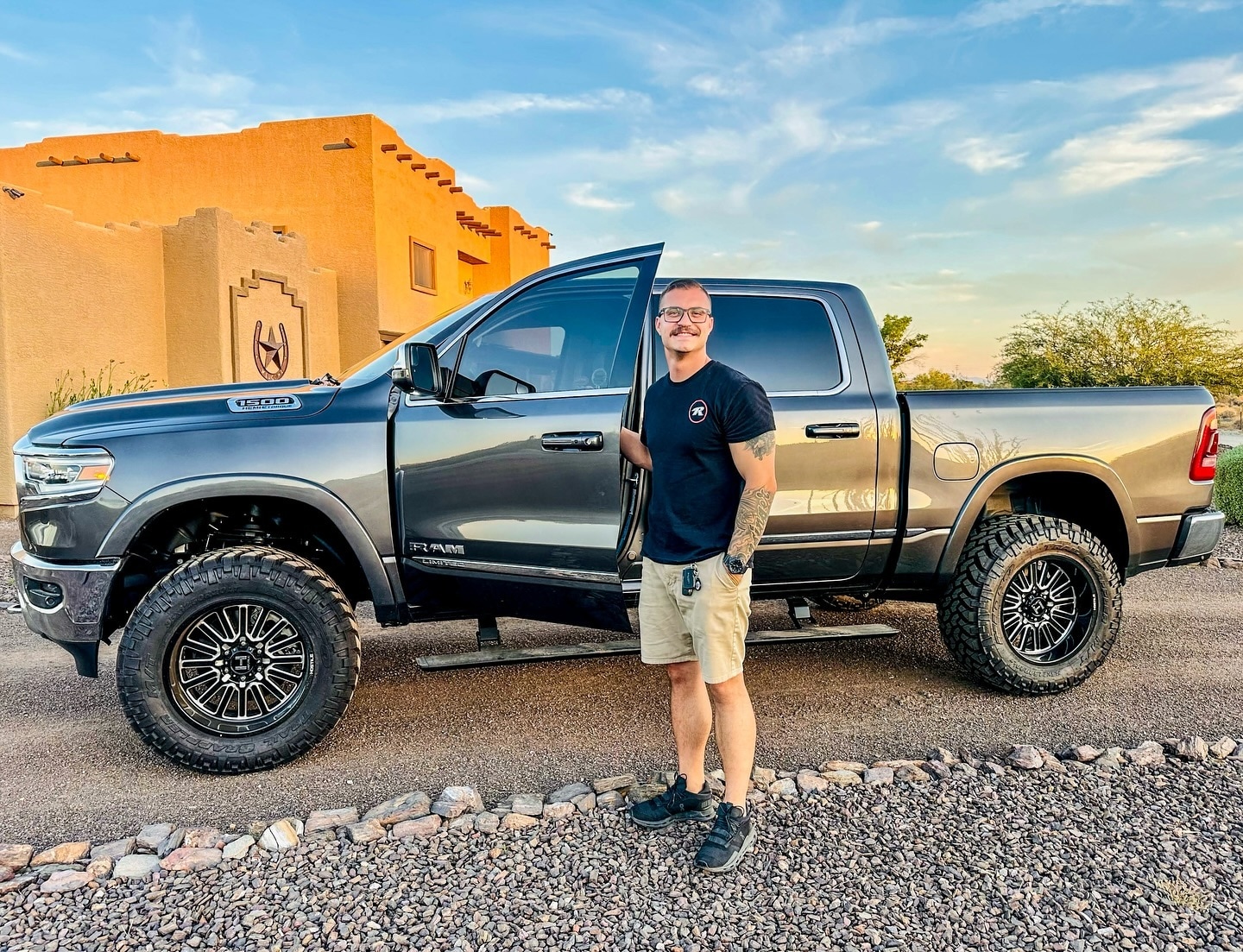 Lifted Trucks customer standing next to his Ram 1500
