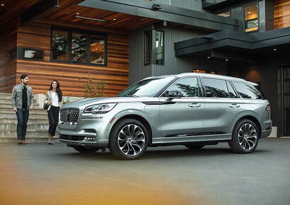 A couple approach a 2023 Lincoln Aviator® Grand Touring model.