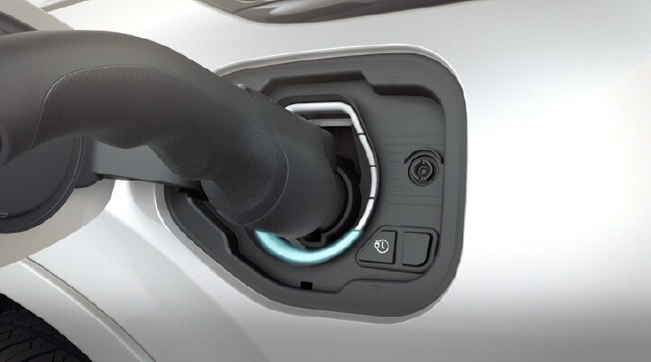An electric charger is shown plugged into the port of a Lincoln Aviator® Grand Touring vehicle.