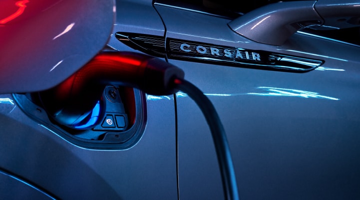A charger plugged into the charging port of a 2024 Lincoln Corsair® Plug-in Hybrid model.