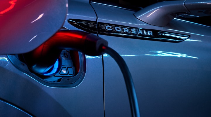 A charger plugged into the charging port of a 2024 Lincoln Corsair® Plug-in Hybrid model.