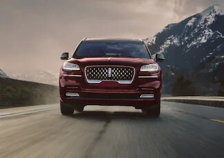 A 2022 Lincoln Aviator® Grand Touring is shown being driven in a river valley