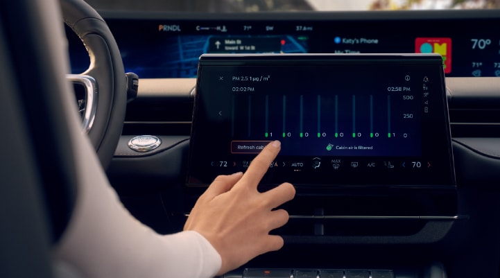 A woman is shown using the Auto Air Refresh feature in the 2026 Lincoln Nautilus® SUV.