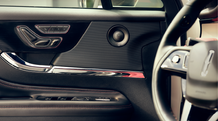 A Revel® audio speaker is shown in the driver’s side door of a 2025 Lincoln Corsair® SUV.
