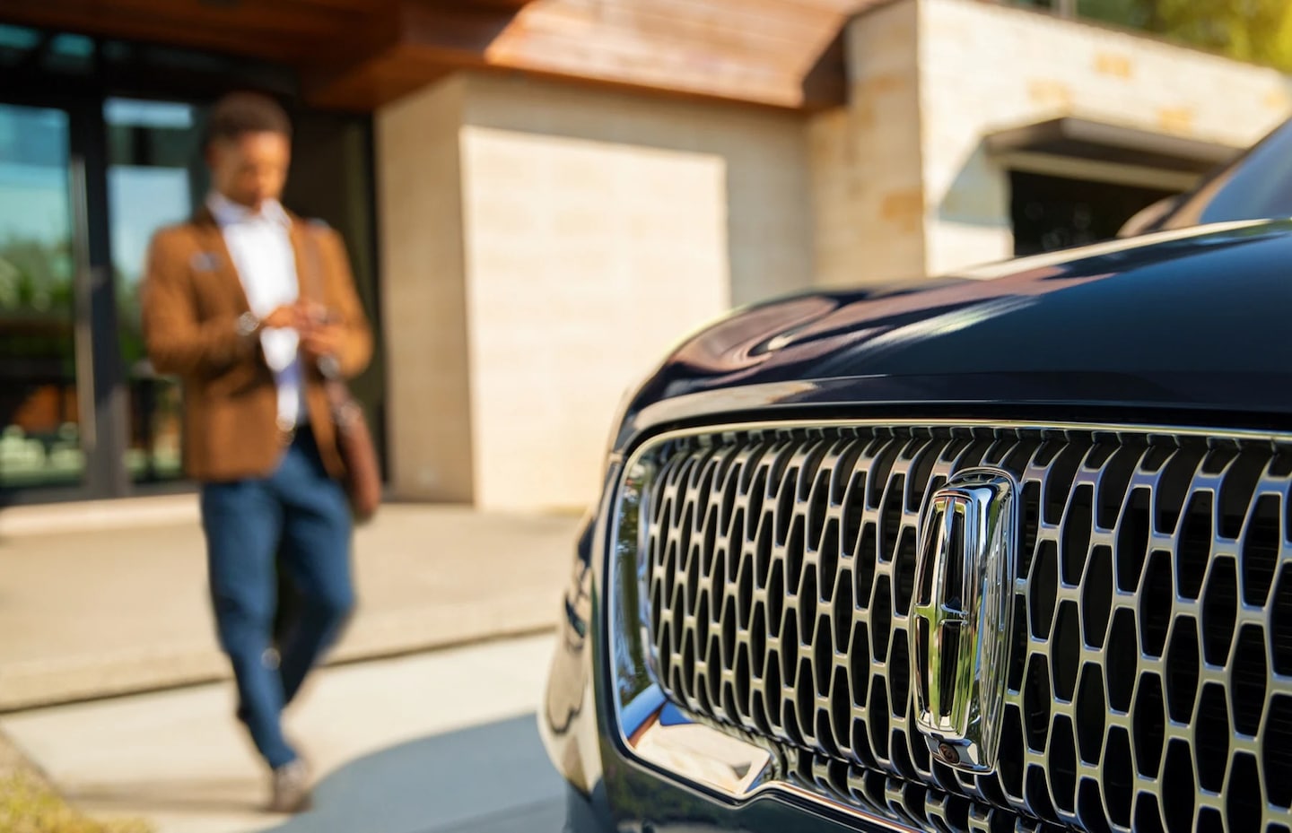  A man walking up to his Lincoln vehicle