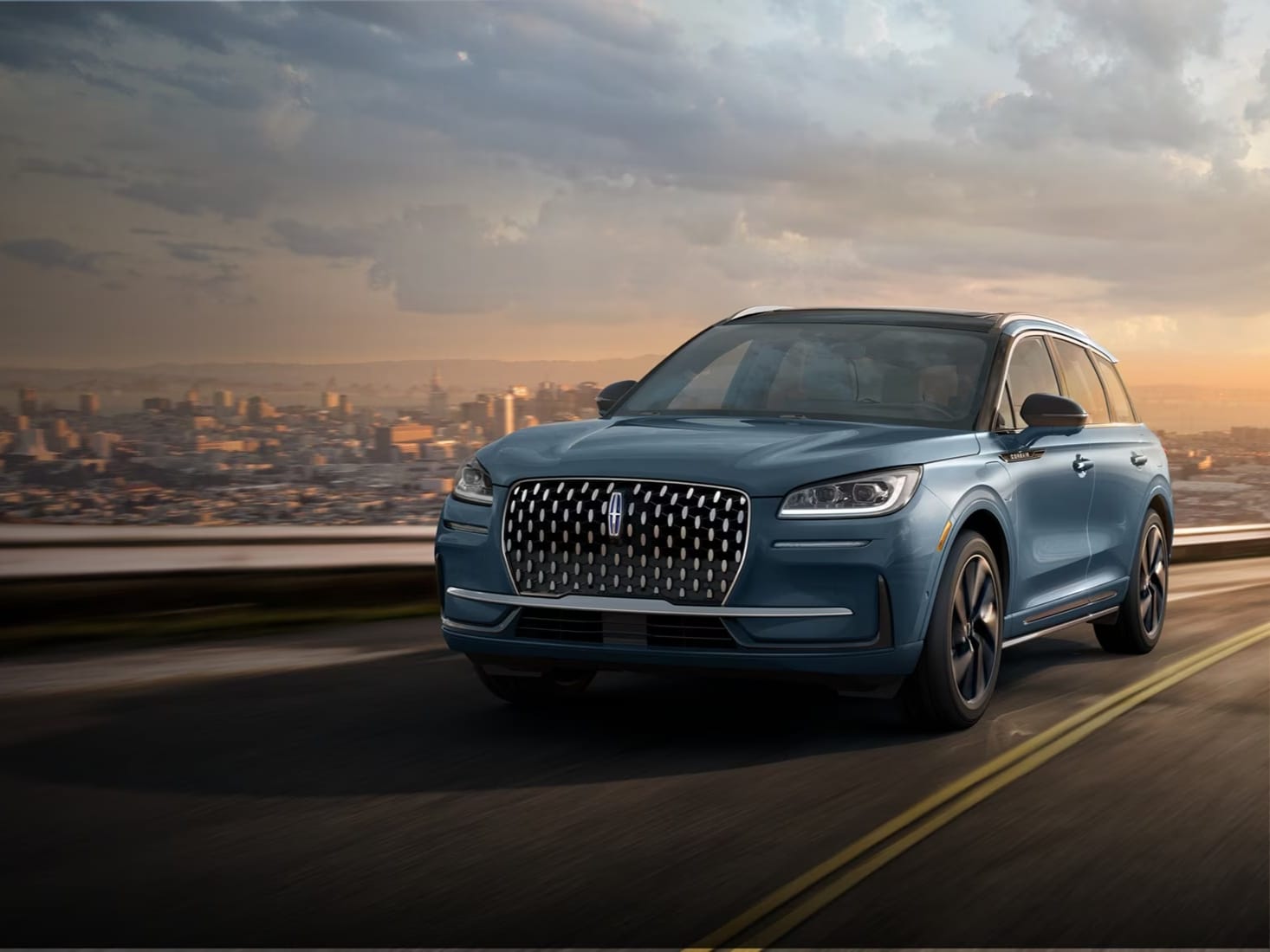 A Lincoln Corsair® SUV is being driven on a scenic country road.