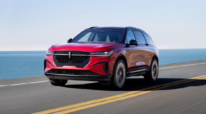 A 2026 Lincoln Nautilus® SUV is being driven on a seaside roadway.