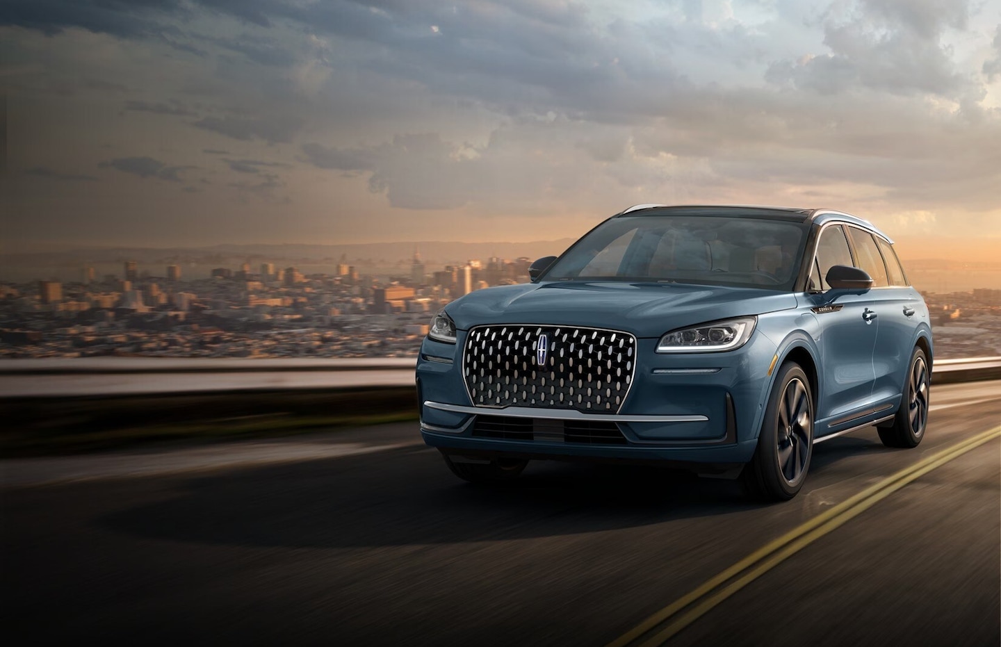 A Lincoln Corsair® SUV is being driven on a scenic country road.