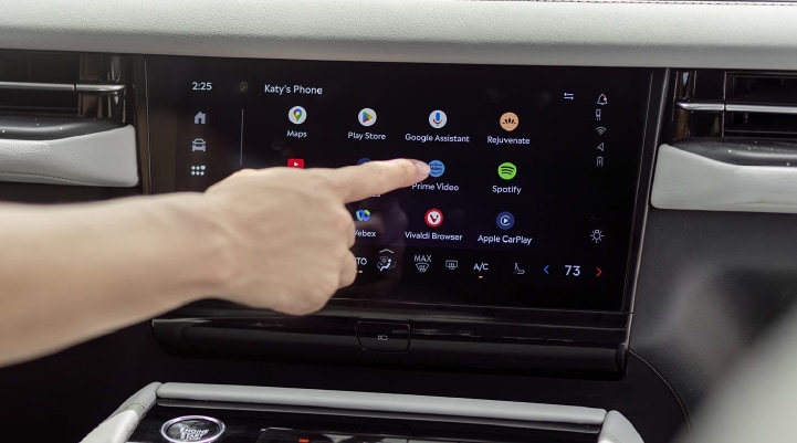  A person interacts with the center touchscreen of a 2026 Lincoln Navigator® SUV.