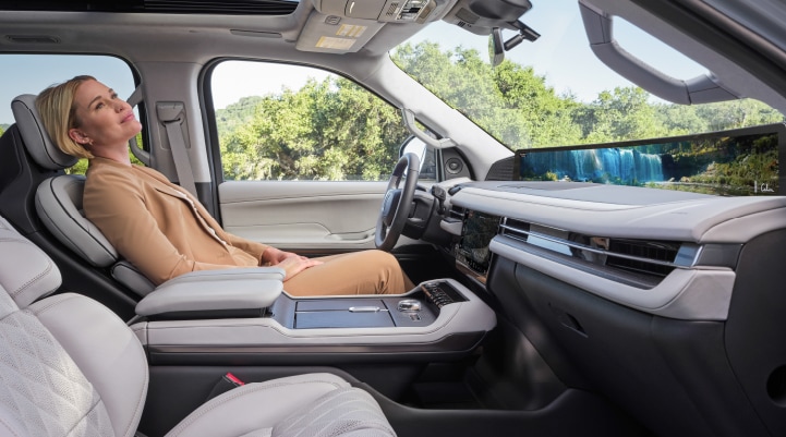 A woman enjoys the Lincoln Rejuvenate experience while seated in a parked 2025 Lincoln Navigator® SUV