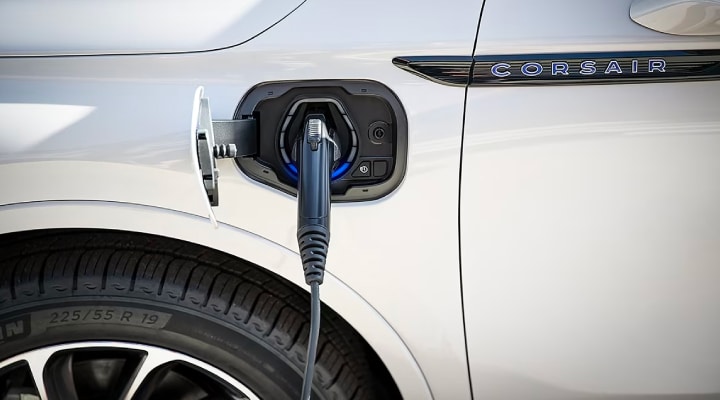An electric charger is shown plugged into the charging port of a Lincoln Corsair® Grand Touring model.