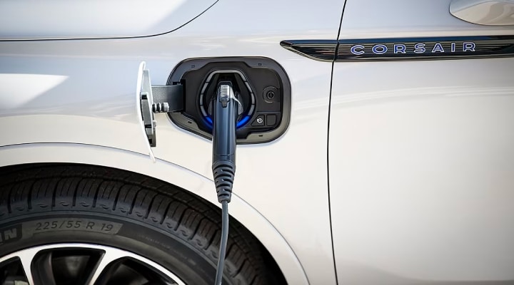 An EV charger plugged into the charging port of a Lincoln Corsair