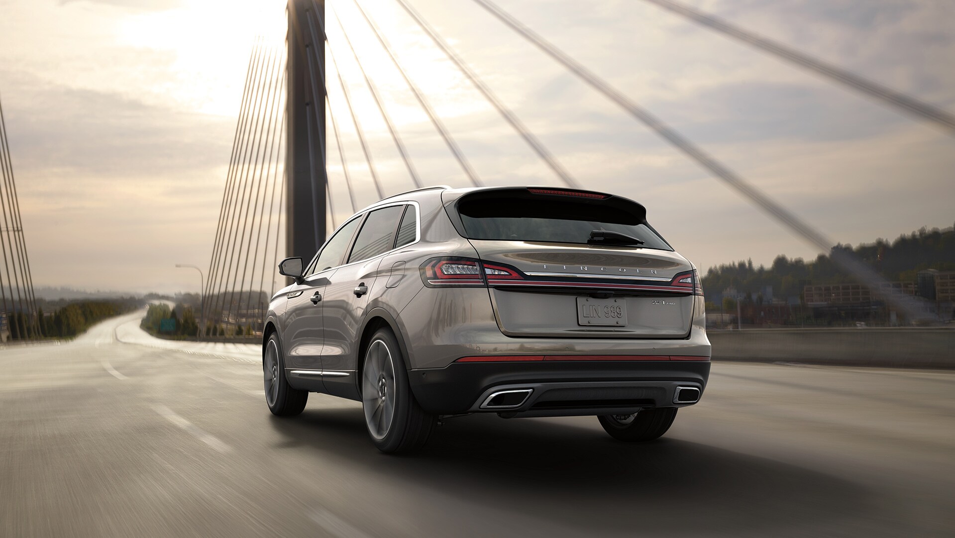 Lincoln of New Bern is a luxury car dealership near Pine Knoll Shores NC | Silver MY20 Lincoln Nautilus driving across bridge