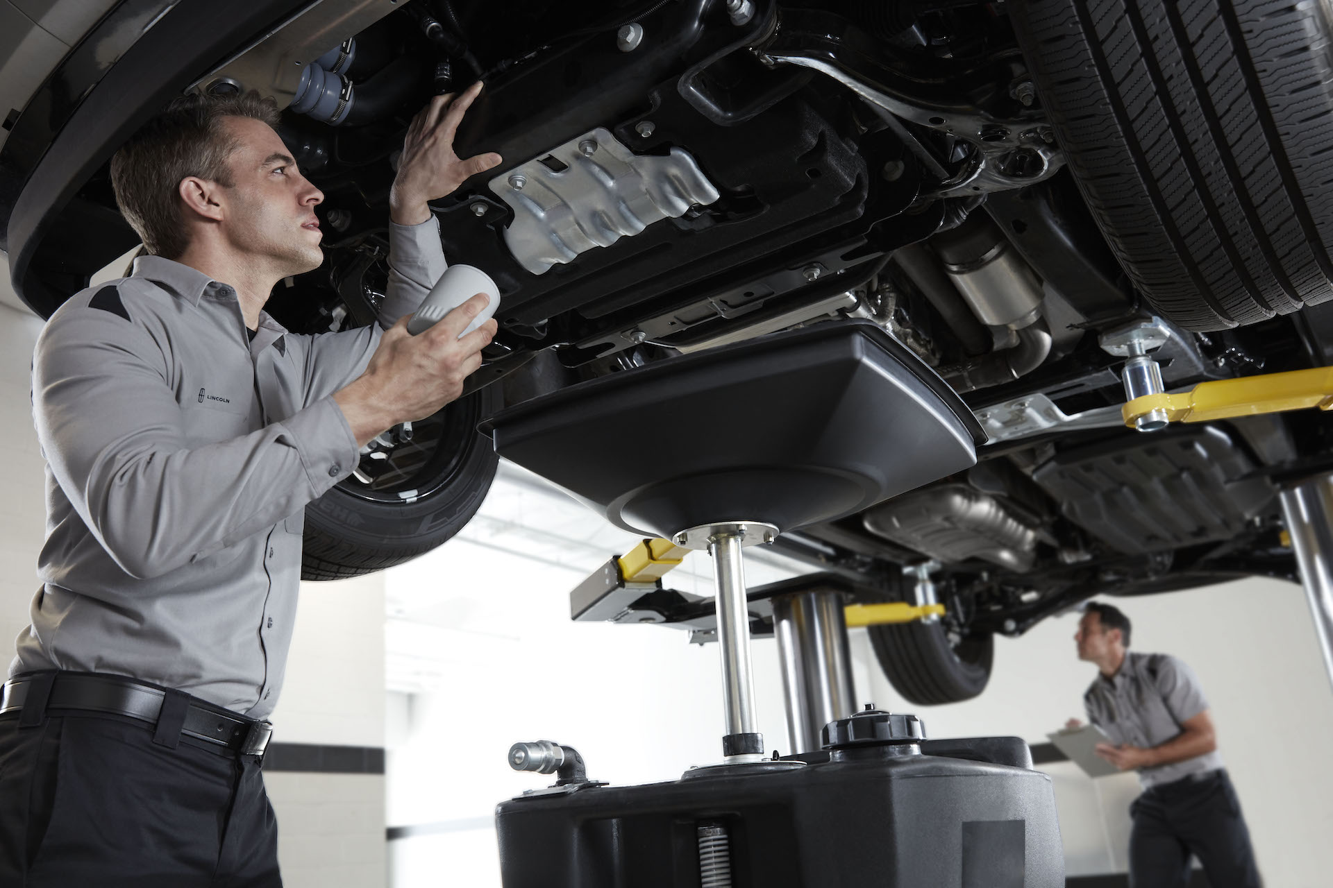 Who makes the best synthetic oil at Lincoln of New Bern in New Bern | Lincoln service technicaian changing oil for Lincoln vehicle