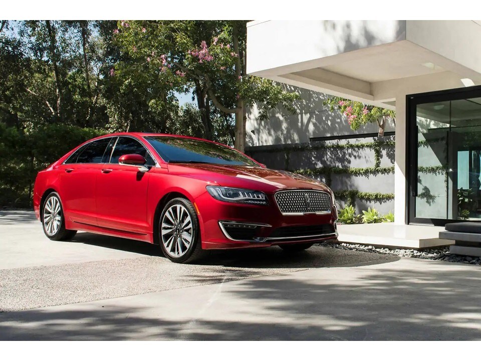 Lincoln of New Bern is a Car Dealership in New Bern near Vanceboro NC | Red 2020 Lincoln MKZ parked in tan driveway