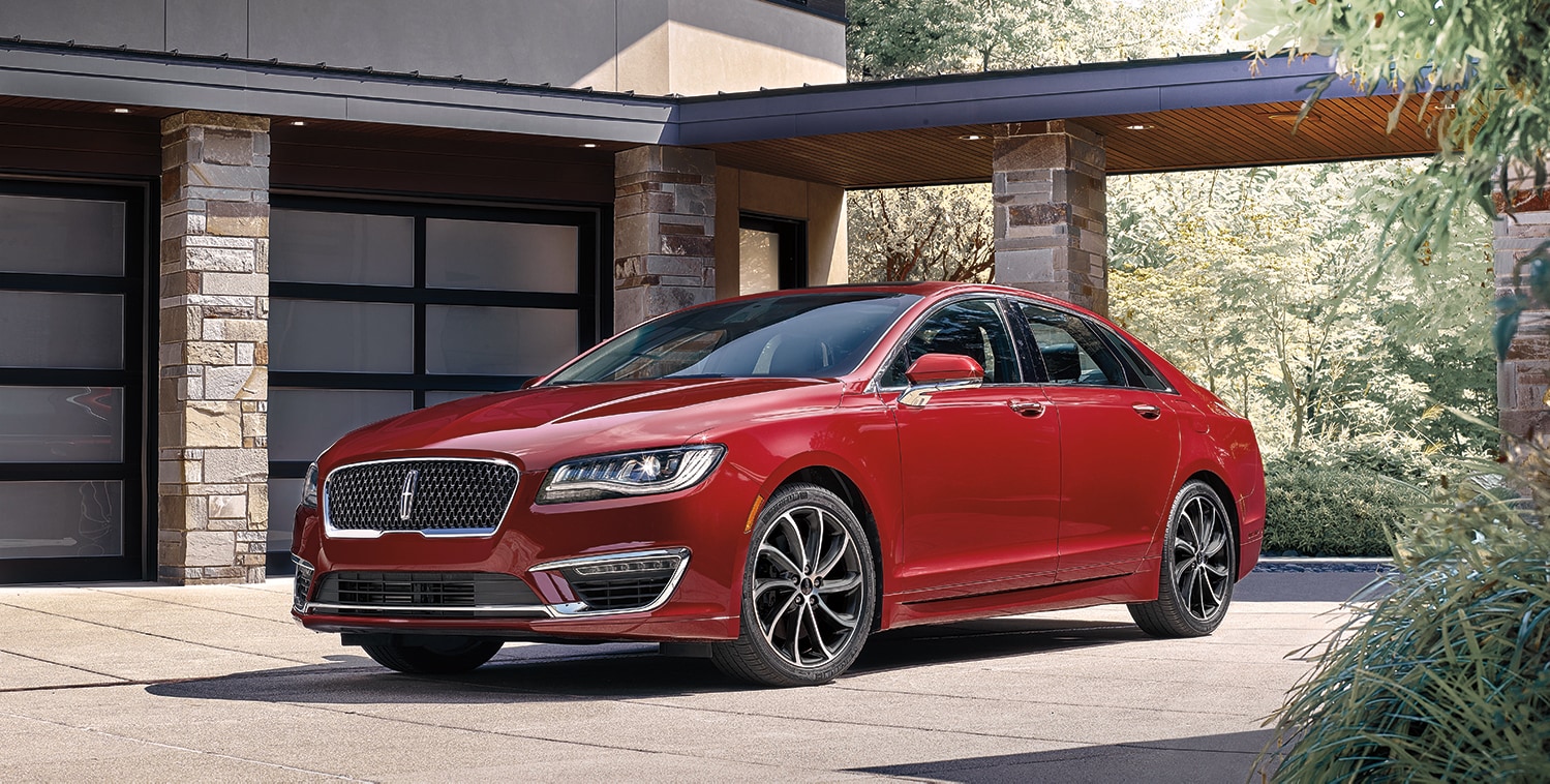 Lincoln of New Bern is a Car Dealership in New Bern near Bridgeton, NC | Red 2020 Lincoln Continental parked in driveway of modern home