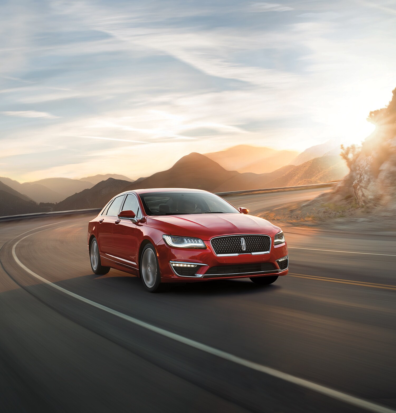 Lincoln of New Bern is a Car Dealership in New Bern near Neuse Forest, NC | Red 2020 Lincoln Continental driving on road at sunset