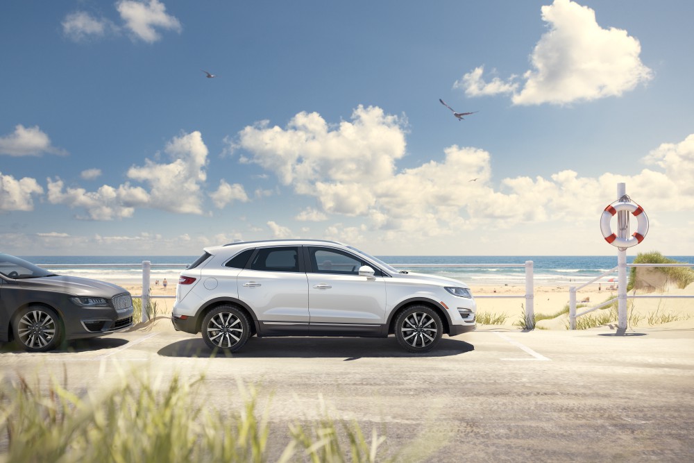 Lincoln of New Bern is a Car Dealership in New Bern near Bridgeton, NC | White 2020 Lincoln Corsair parked by the beach