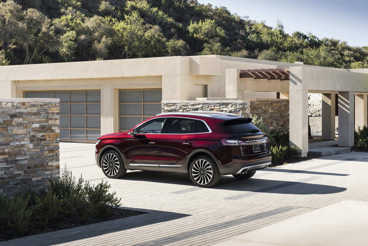  How to check your tires' health at Lincoln of New Bern | Red 2020 Lincoln Nautilus pulling into driveway of modern home