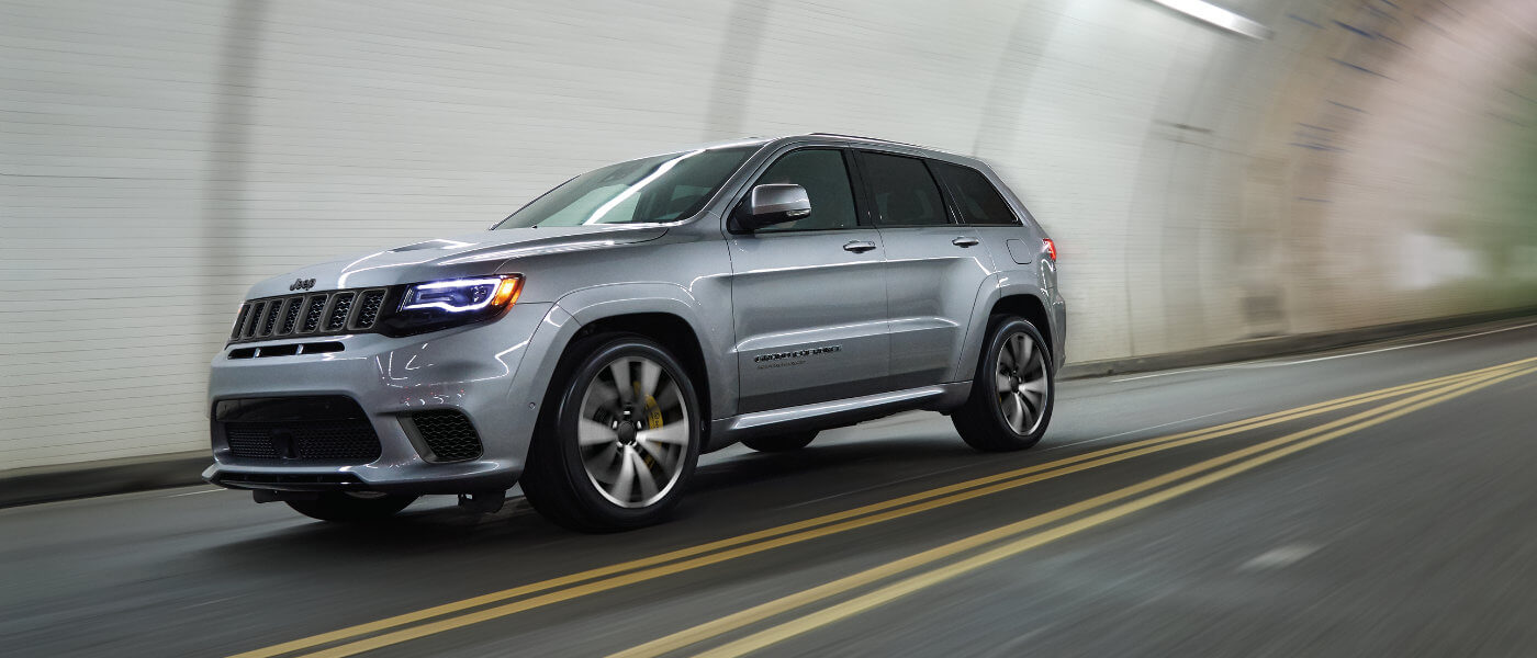 Silver Grand Cherokee driving in tunnel