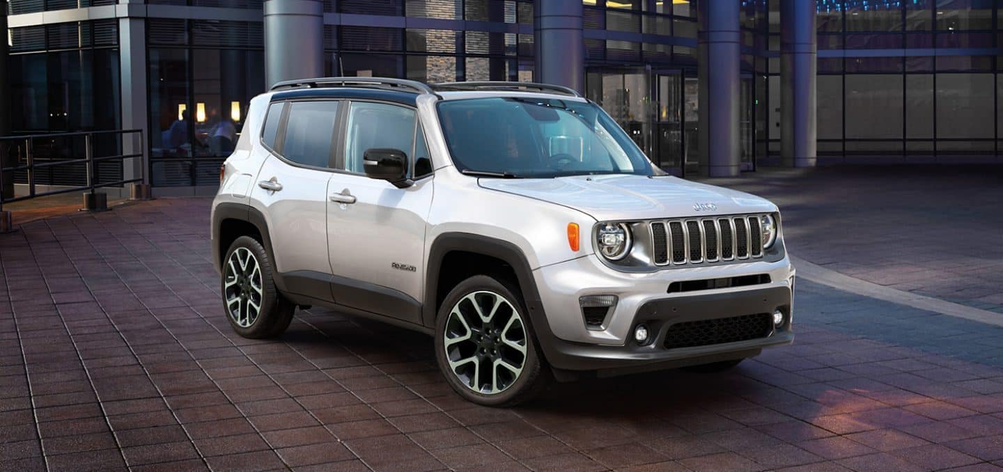 white Jeep Renegade SUV parked in front of an office building