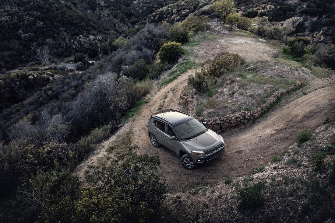 2025-Jeep-Compass-Trailhawk-SUV-L04.png Jeep Compass rounding the corner on a steep hill, aerial view