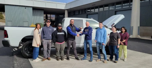 General Sales Manager Brandon Berg handing over keys to Oregon Tech