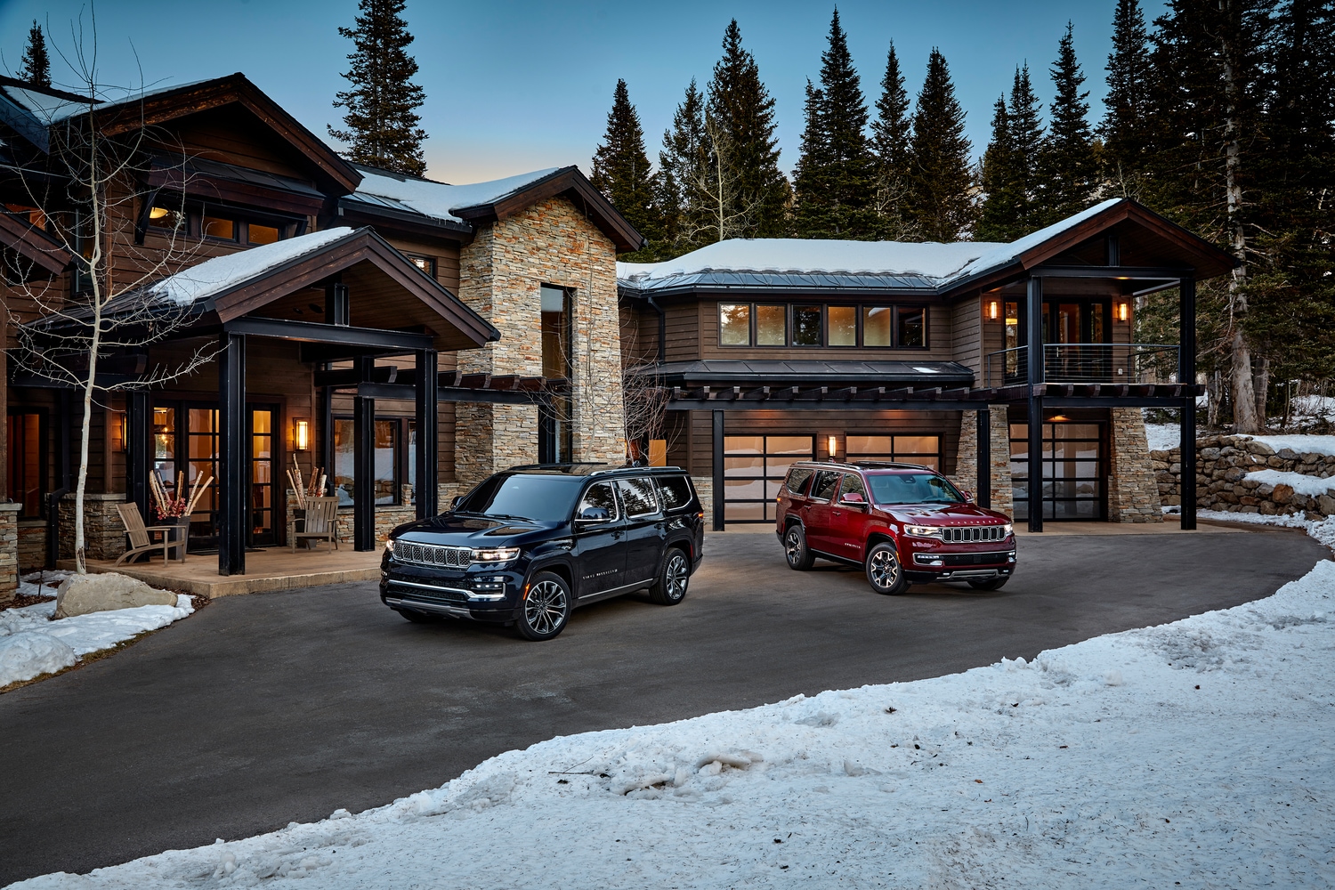 black and red Jeep Wagoneer SUVs parked in front of a lodge