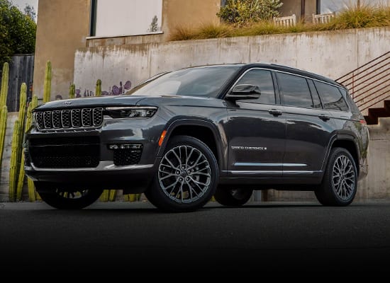 black Jeep Grand Cherokee SUV parked on a blacktop driveway