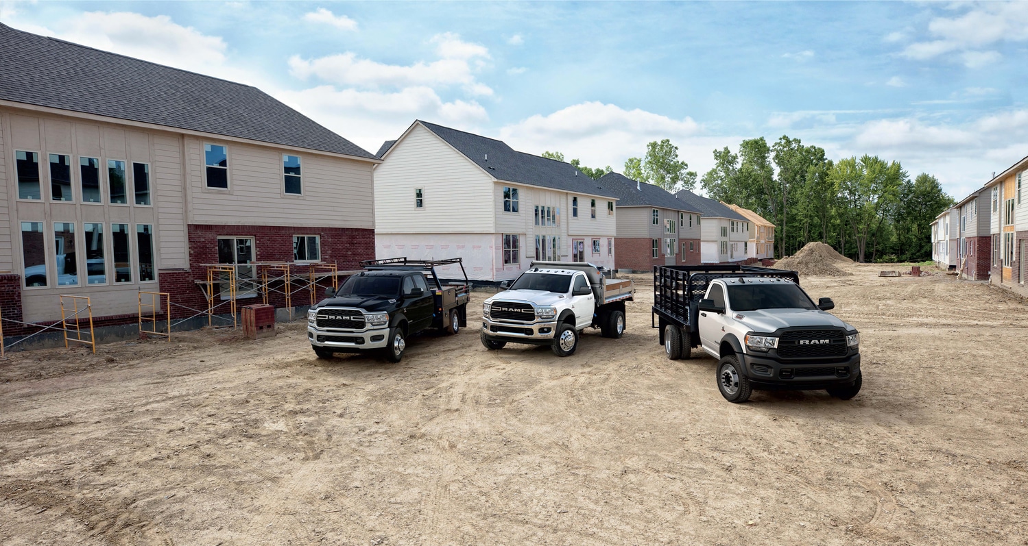 new ram 2500 and 3500 trucks parked on a construction site