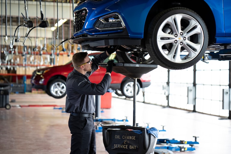 Chevrolet mechanic working on a vehicle
