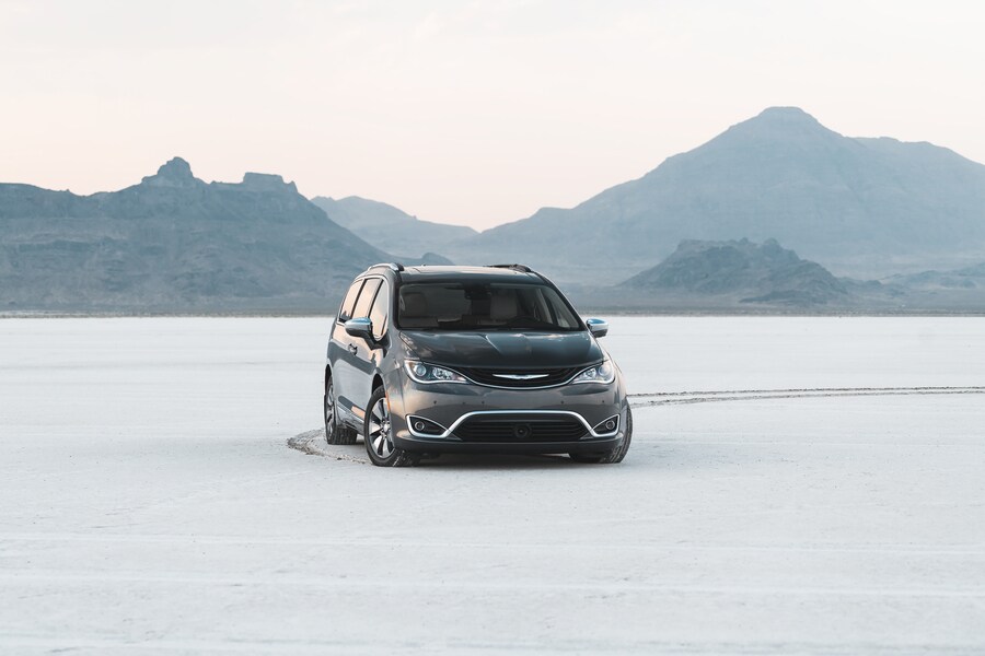 teal Chrysler Pacifica van parked in the snow