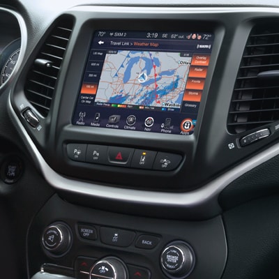 The center section of the dash in a new Jeep Cherokee, the screen displaying a map.